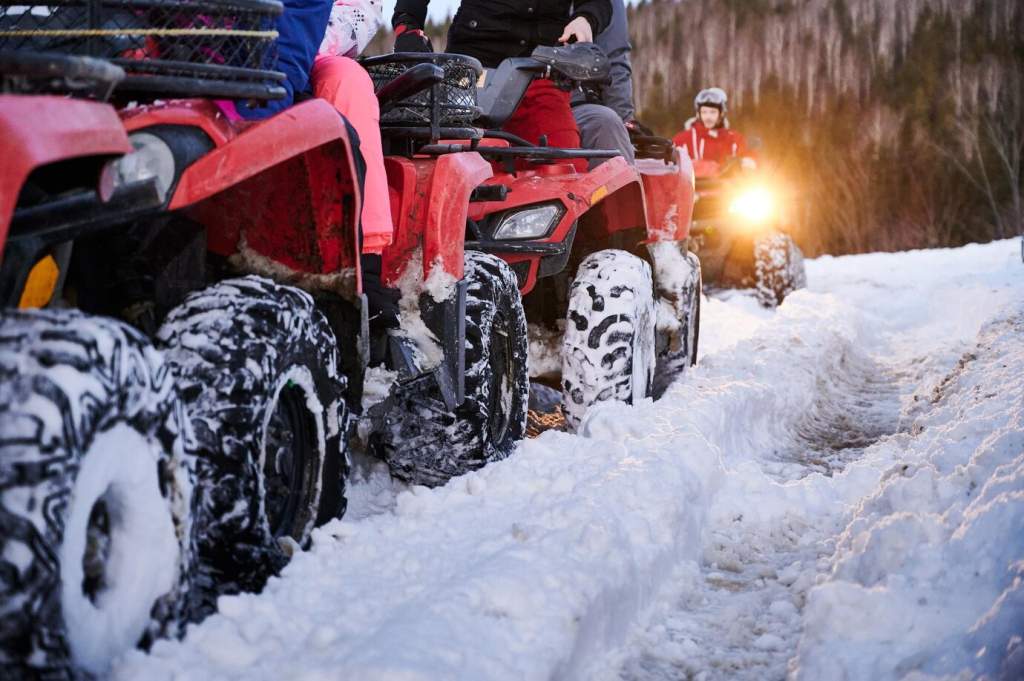 group-of-people-driving-quad-bikes-on-snowy-road_651396-2174.jpg